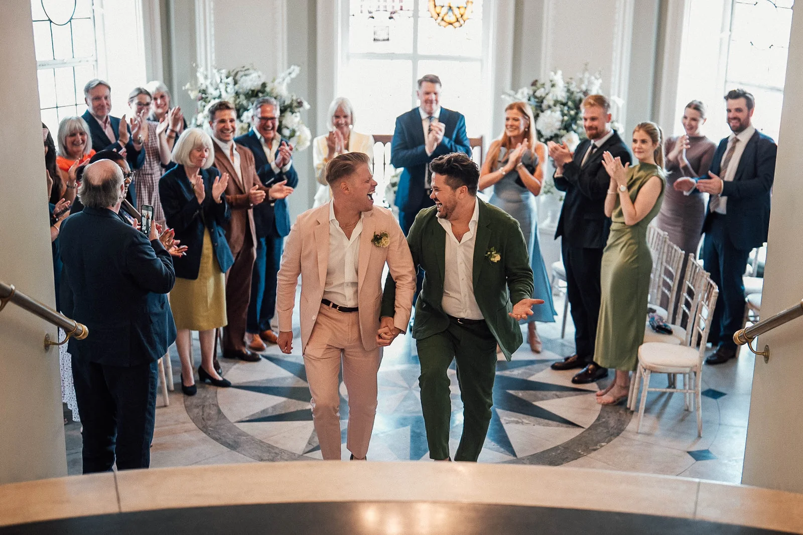 Our wedding day, walking hand in hand as friends and family applaud